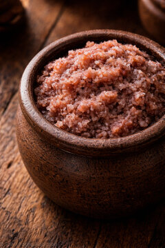 Shrimp Paste Kapi with Coarse Texture in Small Clay Jar on Teak Wood Table under Low Amber Tungsten Light in Local Market