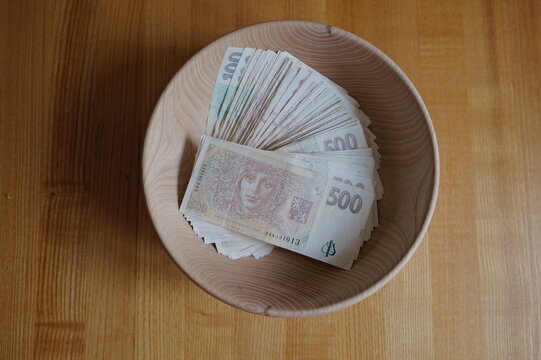 wooden bowl full of paper banknotes