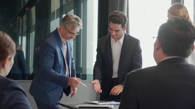 Successful business partner shaking hands after signing contract, corporate team applauding and celebrating deal, partnership agreement in modern office, business team meeting and congratulating.