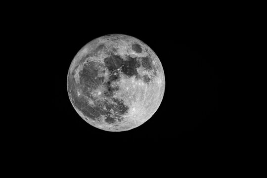 Serene lunar landscape highlighting crater textures and starry background, fullmoon in may