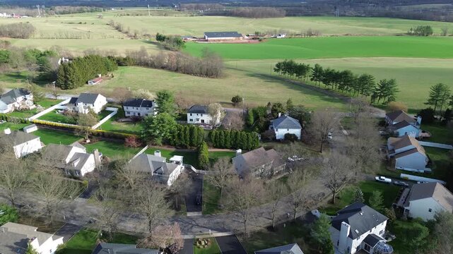 Curved neighborhood streets just off Old York Road border wide agricultural tracts stretching toward Three Bridges, creating defined edge between housing open fields. Readington, NJ