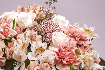 Naklejka premium Bouquet of soft pink flowers in wrapping paper.