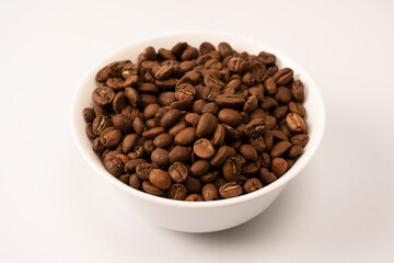 Fototapeta premium Coffee beans on a white background. Top view. Coffee beans texture.