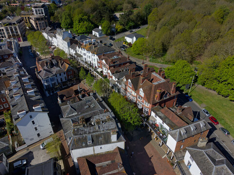 Above Pantiles at Royal Tunbridge Wells in springtime. Aerial view of historic street with restaurants, cafes and hotels. Tourist attraction in Kent and popular street for dinning on a sunny day.