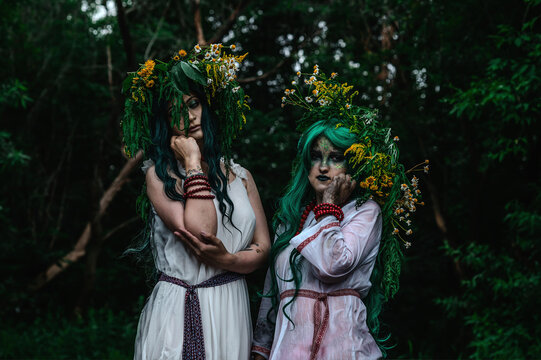 Rusalka in white with a wreath on her head and green hair