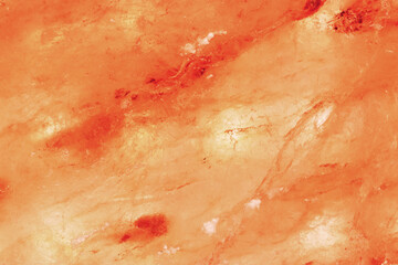 Fototapeta premium Natural Himalayan salt surface with organic crystal structure and warm tones. Concept of wellness, clean beauty aesthetics. Mineral texture salt slab nature background, pink peach monochrome.