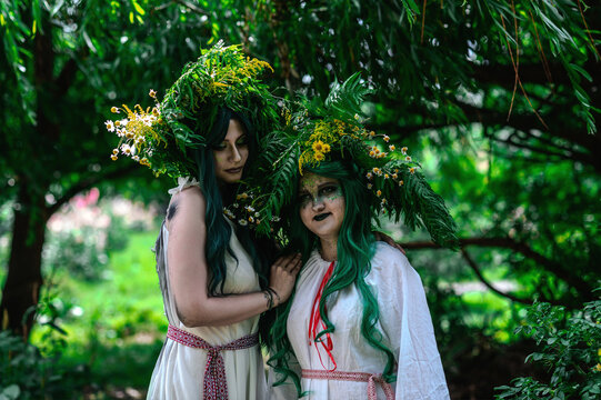 Rusalka in white with a wreath on her head and green hair