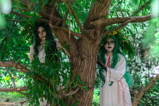 Rusalka in white with a wreath on her head and green hair