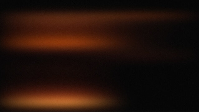 Blurry orange light streaks on dark background with glowing effect