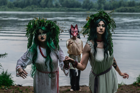 Rusalka in white with a wreath on her head and green hair