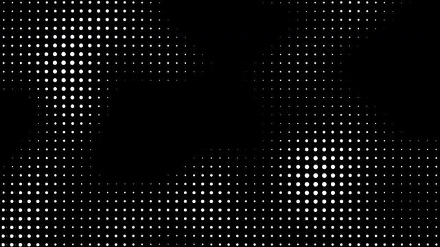 White halftone dots move and change size on a black background with alpha channel creating a dynamic pattern of circles that flow across the dark digital screen display.