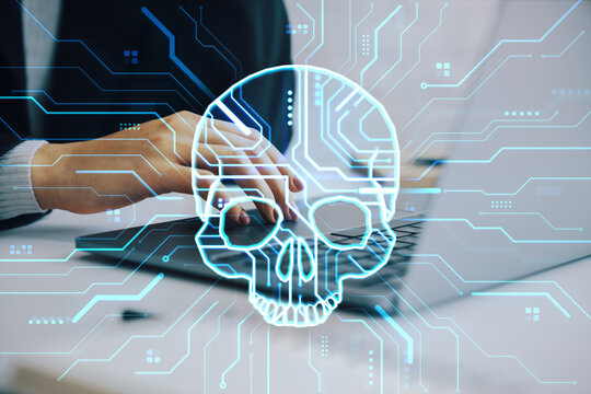 Cyber skull overlay with circuit lines above hands typing on laptop in office setting showing digital threat concept in modern abstract tech scene.