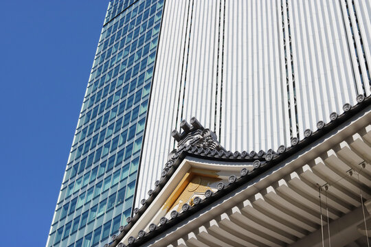 TOKYO, JAPAN - February 3, 2021: Detail of the Kabuki-za kabuki theater's roof with the Kabukiza Tower office building behind it.