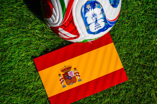 ATLANTA, USA, APRIL 21, 2026: Spain National Flag and Official FIFA 2026 Match Ball on Professional Pitch. World Cup Background.