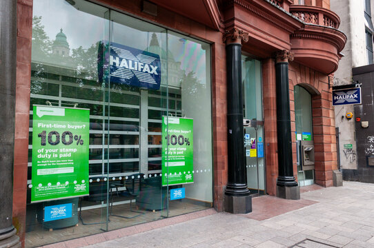 Exterior of a Halifax bank branch on a high street, showcasing the prominent signage and corporate branding of the financial institution before its 2026 rebranding to Lloyds.