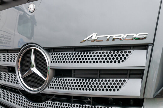 Close-up of the front grille and iconic star emblem of a Mercedes-Benz Actros truck, highlighting the sleek automotive design and engineering excellence of this German heavy-duty long-haul vehicle.