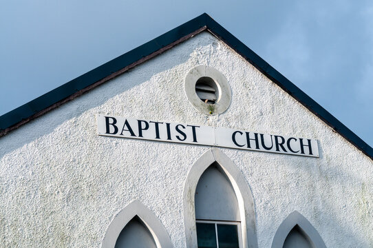 A simple sign saying "Baptist church"  serving as a peaceful sanctuary for the local community.