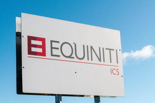 The modern, glass-fronted offices of Equiniti ICS located within the Catalyst campus at Belfast's Titanic Quarter, reflecting the area's reputation as a growing hub for technology and innovation.