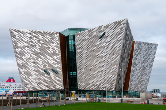 Titanic Belfast, showcasing the complex steel skeleton of the angular prow-shaped structure rising from the historic site of the Harland and Wolff shipyard where the famous ocean liner was built.