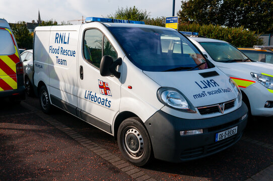 An official RNLI Flood Rescue Team emergency response van, parked outdoors with specialized water rescue equipment visible, ready for deployment in severe weather conditions.