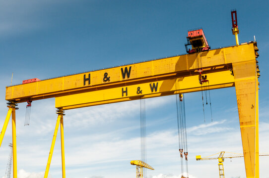 An expansive view of the iconic yellow Samson and Goliath gantry cranes towering over the Harland and Wolff shipyard in Belfast&rsquo;s Titanic Quarter, symbolizing the city's rich industrial heritage.