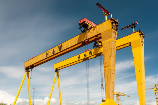 An expansive view of the iconic yellow Samson and Goliath gantry cranes towering over the Harland and Wolff shipyard in Belfast&rsquo;s Titanic Quarter, symbolizing the city's rich industrial heritage.