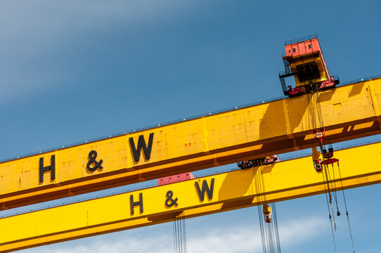 An expansive view of the iconic yellow Samson and Goliath gantry cranes towering over the Harland and Wolff shipyard in Belfast&rsquo;s Titanic Quarter, symbolizing the city's rich industrial heritage.