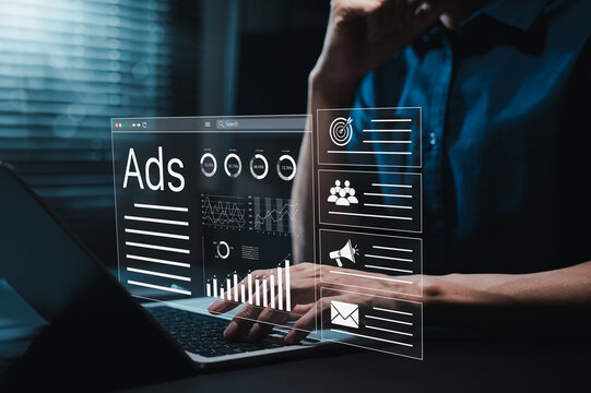 Digital marketing advertising concept. Person using laptop with virtual dashboard icons showing social media ads data, online content platform, campaign performance, target analytics, ad metrics,