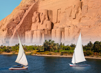 Naklejka premium Beautiful Nile scenery with sailboat in the Nile on the way to The Front of the Abu Simbel Temple - Egypt, Africa