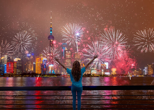 New year's fireworks in Shanghai - Shanghai colorful skyline with motion speed light of passing ferry in the foreground at night - Shanghai, China