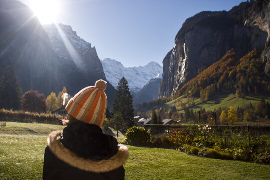 Woman viewing sunrise in Lauterbrunnen Valley, Switzerland during autumn season