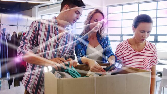 Retail team opening box and sorting garments, checking stock as pink streaks highlighting rack