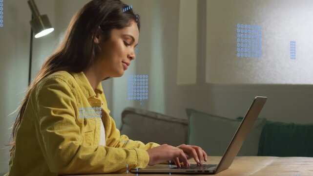 Woman typing on laptop at home, causing blue HUD overlays passing over screen for tech work