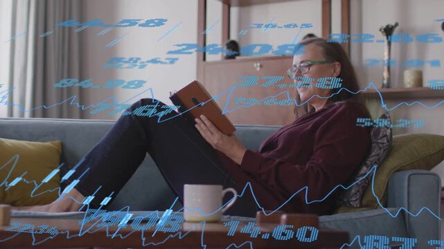 Animated blue financial overlays appearing and moving across woman reading book for rest on sofa
