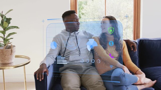 Couple sitting while holo finance UI appearing, charts updating, reviewing finances and smiling