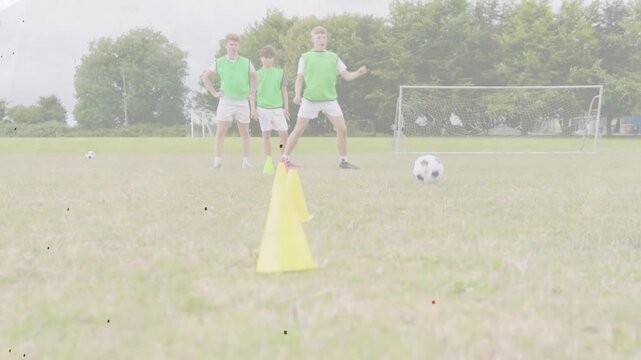 Teen players rotating cone dribbling in soccer, player stepping up training close touches with ball