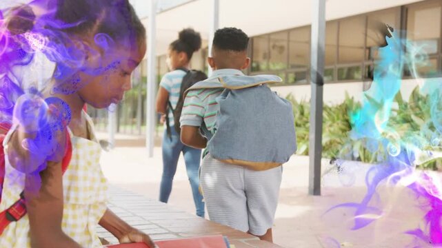 Students rising and walking after girl from bench slinging packs holding binder purple-blue edging