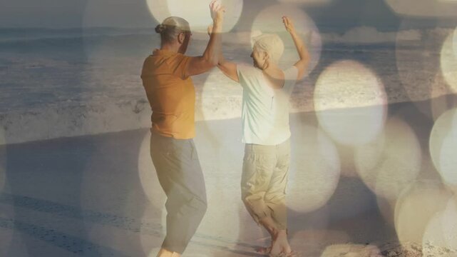 Couple responding to cue, mirroring while walking shore, bokeh overlays showing movement for health