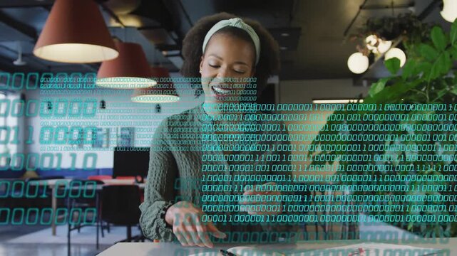 Female speaker speaking and starting binary overlay across torso while writing in notebook for tech