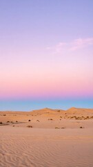 Fototapeta premium A vertical desert landscape bathed in pastel colors during sunrise or sunset