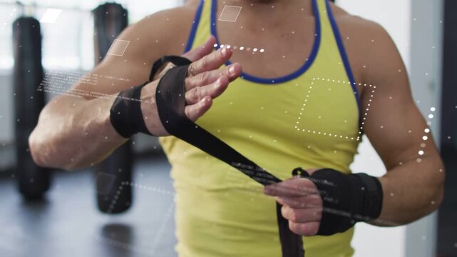Man wrapping hands before training, winding wrap over knuckles and securing with overlays static