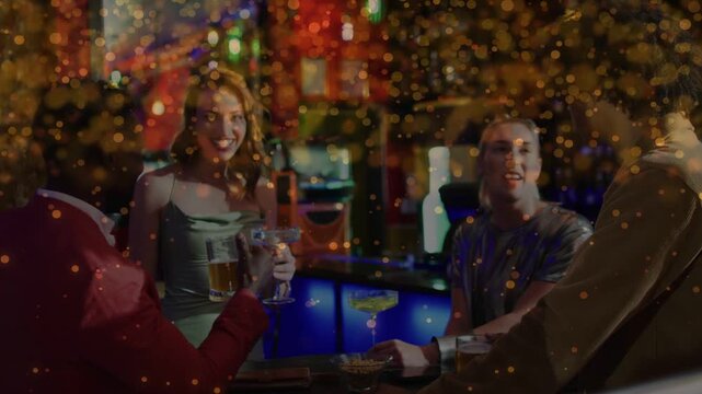 Man in red jacket raising mug sparking crew toasting and cheering in nightlife, confetti overlaying