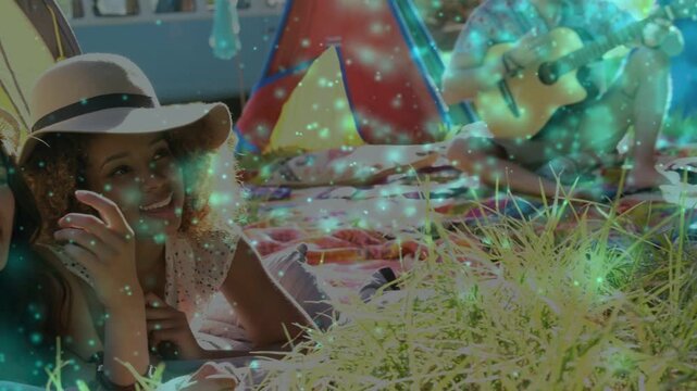 Second woman joining, cam framing two women smiling, guitar playing, teal overlay for travel calm