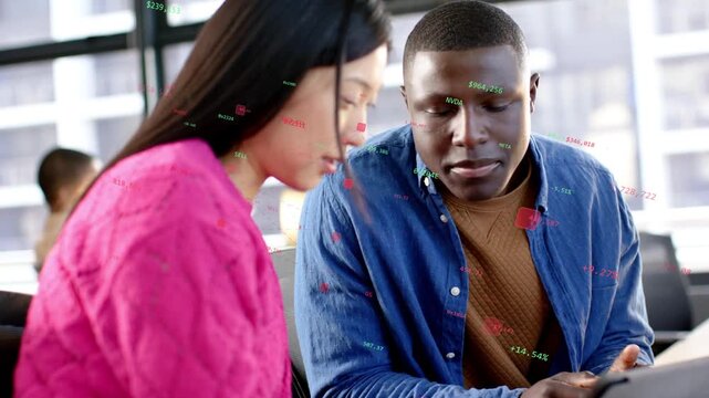 Man pointing, explaining; woman tapping tablet in business office, animated graphs guiding decision