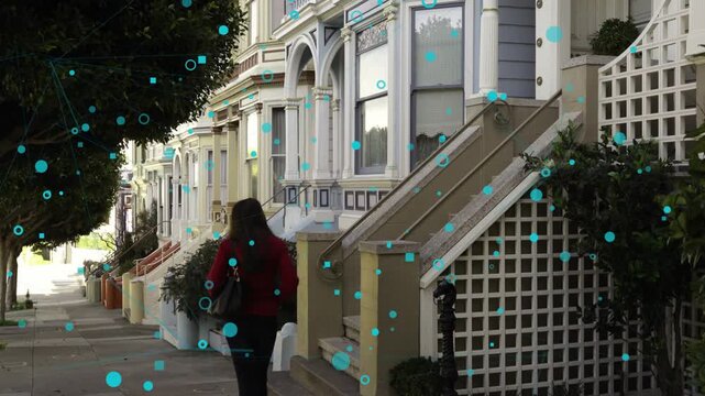 Woman entering from right walking past Victorian houses, teal technology markers overlaying frame