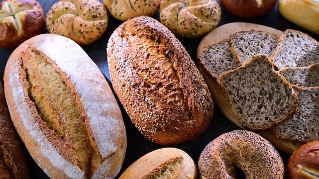 Assorted bakery products including loaves of bread and rolls.