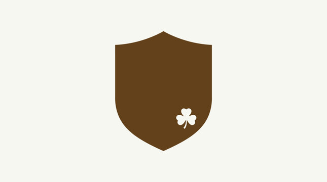 A brown shield with a white shamrock emblem on a beige background