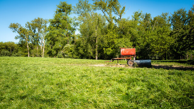 Old manure cart in a spring landscape