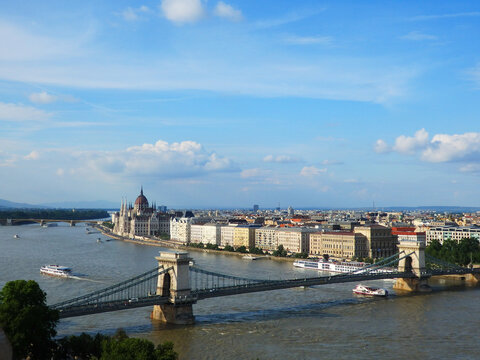 Panoramic view of Budapest, Hungary: Sz&eacute;chenyi Chain Bridge, Hungarian Parliament Building, and Danube River.