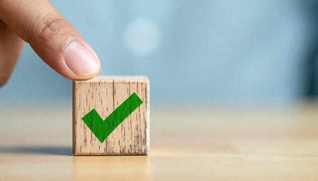 Hand Placing Wooden Block with Green Check Mark Icon for Success and Approval